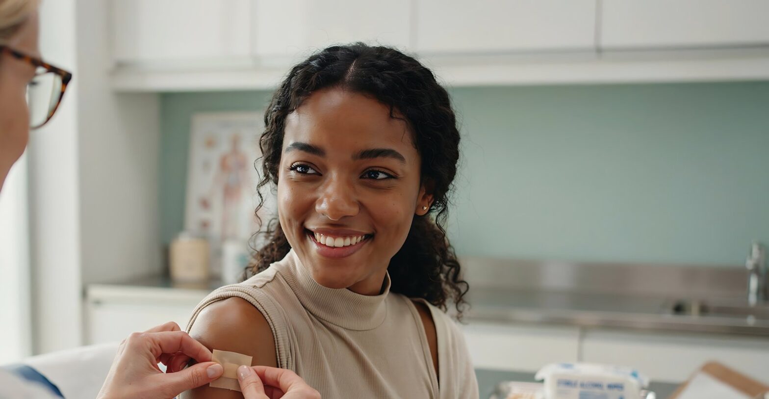Smiling woman having a plaster applied after her flu jab